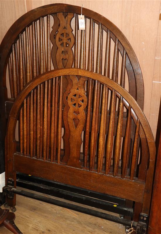 A pair of oak spindle and wheel back head and foot single bedsteads W.91.5cm